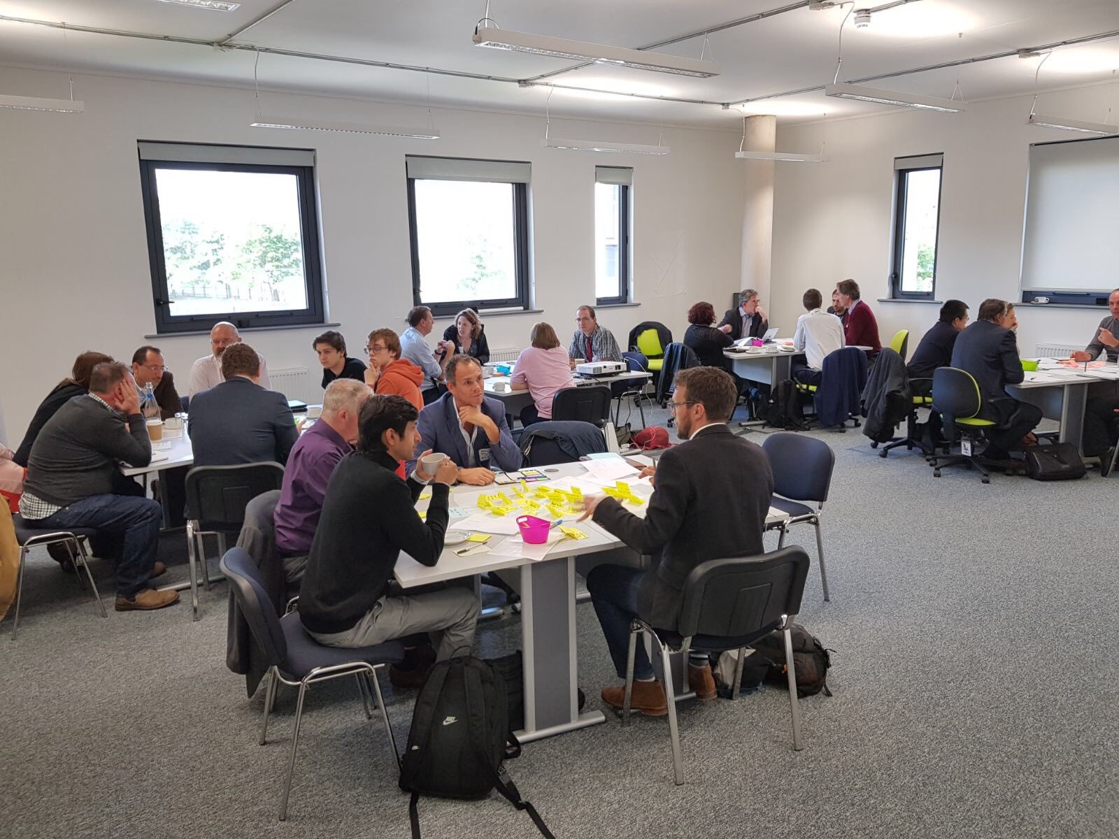 Workshop participants working in small groups around tables